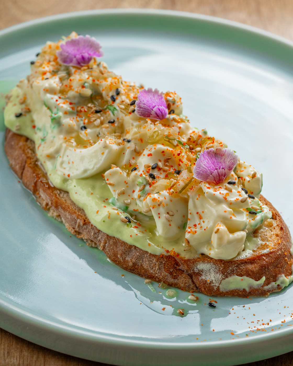 Avocado tartine with edible flowers
